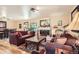 Comfortable living room with fireplace, hardwood floors, and abundant seating at 6940 W 63Rd Ave, Arvada, CO 80003