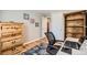 Comfortable home office with hardwood floors, a large window, and a wood bookcase at 6940 W 63Rd Ave, Arvada, CO 80003
