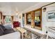 Cozy sunroom with exposed brick and wood accents with ample seating at 6940 W 63Rd Ave, Arvada, CO 80003