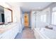 Elegant bathroom includes a double vanity, a soaking tub, a glass-enclosed shower, and a walk-in closet at 7243 S Old Hammer Ct, Aurora, CO 80016