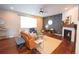 Stylish living room features a fireplace, hardwood floors, and neutral color palette with lots of natural light at 7243 S Old Hammer Ct, Aurora, CO 80016