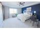 Spacious main bedroom showcases a tray ceiling, a large window, a ceiling fan, and a calming color scheme at 7243 S Old Hammer Ct, Aurora, CO 80016