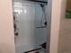 Bathroom featuring a tub and shower combo with a black framed sliding glass door and toiletries shelf at 3550 S Harlan St # 313, Denver, CO 80235