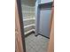 Walk-in closet with ample shelving, tiled floor, and hanging rod for organized storage at 3550 S Harlan St # 313, Denver, CO 80235