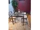 Contemporary dining area with a glass table, seating for four, and stylish decor at 3550 S Harlan St # 313, Denver, CO 80235