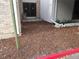 A neatly mulched area outside the home's entrance with a red curb and well-maintained plants at 3550 S Harlan St # 313, Denver, CO 80235