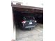Garage containing a black Nissan Pathfinder with parking spot marked by number 151 at 3550 S Harlan St # 313, Denver, CO 80235