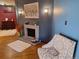 Inviting living room showcases a brick fireplace, hardwood floors, and a comfortable accent chair at 3550 S Harlan St # 313, Denver, CO 80235