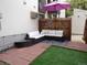 Cozy patio area with comfortable seating, a purple umbrella, and a small garden area for outdoor enjoyment at 3550 S Harlan St # 313, Denver, CO 80235