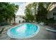 Outdoor community pool surrounded by ample seating, lush trees and landscaping for recreational enjoyment at 3550 S Harlan St # 313, Denver, CO 80235