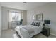 Bright bedroom features a bed with plaid pillows, a desk by the window, and neutral decor at 1919 Breen Ln, Superior, CO 80027