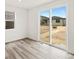 A bright room with a sliding glass door providing an outdoor view of the new backyard at 547 Homestead Ave, Brighton, CO 80601