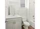 Spotless bathroom with a vanity, toilet, mirror, and a bathtub-shower combination featuring white tile at 547 Homestead Ave, Brighton, CO 80601