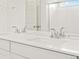 Bathroom featuring modern double sinks and a large mirror at 547 Homestead Ave, Brighton, CO 80601