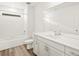 Bathroom featuring a tub shower, vinyl flooring, and vanity with a modern faucet at 547 Homestead Ave, Brighton, CO 80601