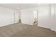Spacious carpeted bedroom with easy access to the bathroom at 547 Homestead Ave, Brighton, CO 80601