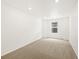 Bright bedroom with neutral carpet, recessed lighting, and a window at 547 Homestead Ave, Brighton, CO 80601