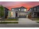 Charming two-story home showcasing a gray brick facade, attached two-car garage, and a well-manicured lawn at 547 Homestead Ave, Brighton, CO 80601