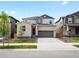 Charming two-story home showcasing a gray brick facade, attached two-car garage, and a well-manicured lawn at 547 Homestead Ave, Brighton, CO 80601