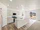 Modern kitchen with white cabinets, an island, and stainless steel appliances, perfect for cooking and entertaining at 547 Homestead Ave, Brighton, CO 80601