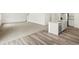 A bright living space with combined wood flooring and carpet next to a kitchen island at 547 Homestead Ave, Brighton, CO 80601