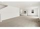 A bright living space with neutral carpet next to a modern kitchen at 547 Homestead Ave, Brighton, CO 80601