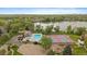 Aerial view of community pool, tennis courts, lake, and lush green surroundings at 8699 Garrison Ct, Arvada, CO 80005