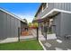 This backyard has grass, a concrete patio, and an awning at 8699 Garrison Ct, Arvada, CO 80005