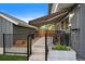 This backyard features grass, a concrete patio, and an awning at 8699 Garrison Ct, Arvada, CO 80005