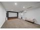 Finished basement area features a movie screen, projector, and accent lighting at 8699 Garrison Ct, Arvada, CO 80005