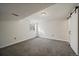 Unfinished basement with carpet flooring, a utility closet, and neutral walls, providing versatile space for storage and hobbies at 8699 Garrison Ct, Arvada, CO 80005