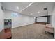 Finished basement with theater area, plush carpet, and natural light from small window at 8699 Garrison Ct, Arvada, CO 80005
