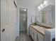 Bathroom featuring vanity with framed mirror and walk-in shower at 8699 Garrison Ct, Arvada, CO 80005