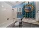 Full bathroom with a tile backsplash, built-in shelves, bathtub, and a unique round mirror adding character at 8699 Garrison Ct, Arvada, CO 80005