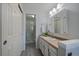 Bathroom featuring a sink with a mirror and cabinet as well as a stand-up shower behind a glass enclosure at 8699 Garrison Ct, Arvada, CO 80005