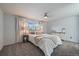 Bright bedroom with soft gray walls, plush carpet, and natural light from the window at 8699 Garrison Ct, Arvada, CO 80005