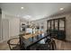 Dining space with views into the kitchen featuring wood floors and decorative cabinet at 8699 Garrison Ct, Arvada, CO 80005