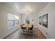 Bright dining area features wood floors, modern lighting, and views from a large window at 8699 Garrison Ct, Arvada, CO 80005