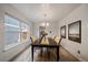 Bright dining room featuring elegant chandelier, neutral decor, and lots of natural light at 8699 Garrison Ct, Arvada, CO 80005