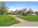 Charming home with lush green lawn and mature landscaping in a desirable community at 8699 Garrison Ct, Arvada, CO 80005