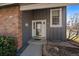 Front door with brick and gray siding at 8699 Garrison Ct, Arvada, CO 80005