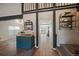 Bright hallway with hardwood floors, open archway, and stylish decor at 8699 Garrison Ct, Arvada, CO 80005