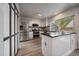 Modern kitchen with stainless steel appliances, white cabinetry, and large center island at 8699 Garrison Ct, Arvada, CO 80005