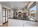 Modern kitchen with stainless steel appliances, white cabinetry, and black countertop island at 8699 Garrison Ct, Arvada, CO 80005