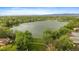Scenic view of the community lake surrounded by mature trees and lush greenery at 8699 Garrison Ct, Arvada, CO 80005