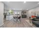 Open living space connects the kitchen and sitting area featuring a charming white brick accent wall at 8699 Garrison Ct, Arvada, CO 80005