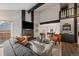 Stylish living room with an open floor plan, fireplace, comfortable seating, and elegant decor at 8699 Garrison Ct, Arvada, CO 80005