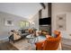 Cozy living room featuring a brick fireplace, vaulted ceilings, and ample natural light at 8699 Garrison Ct, Arvada, CO 80005