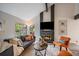 Inviting living room with a fireplace, sofa, accent chairs, and views of the outdoors at 8699 Garrison Ct, Arvada, CO 80005