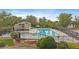 This community pool is surrounded by trees and has tennis courts at 8699 Garrison Ct, Arvada, CO 80005